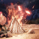A pink-haired, gray-bearded character sits by a campfire in a screenshot from New World.